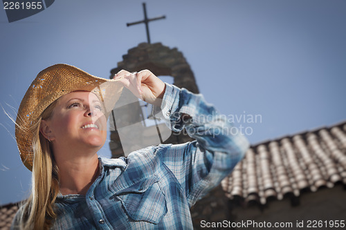 Image of Beautiful Cowgirl Portrait with Old Church Behind