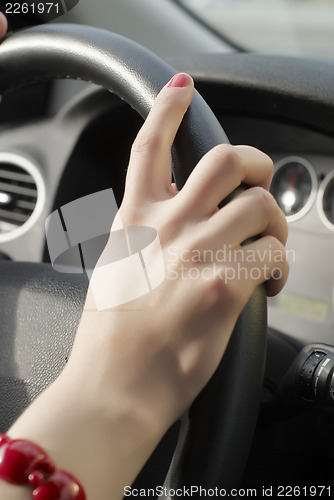 Image of Girl hand on wheel steering