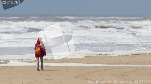 Image of Woman walking on the beach