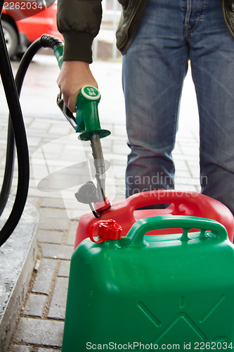 Image of Man in jeans gas station in a plastic gasoline
