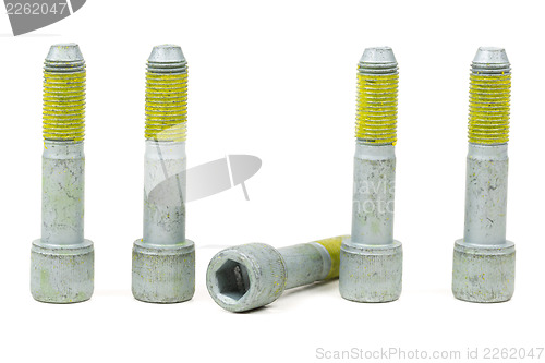 Image of Five bolts for the car with the yellow glue on the threads.