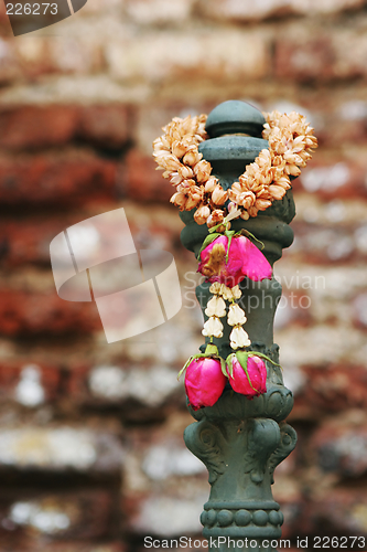 Image of Garland of flowers hanging at a temple in Thailand