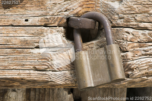 Image of Old rotten board with padlock