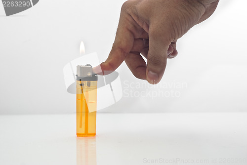 Image of male hand holding a orange lighters isolated
