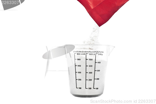 Image of Pouring flour on Kitchen measuring cup