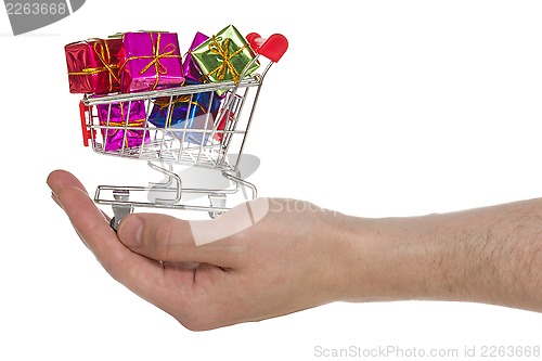 Image of Hand with shopping cart full of colorful gifts