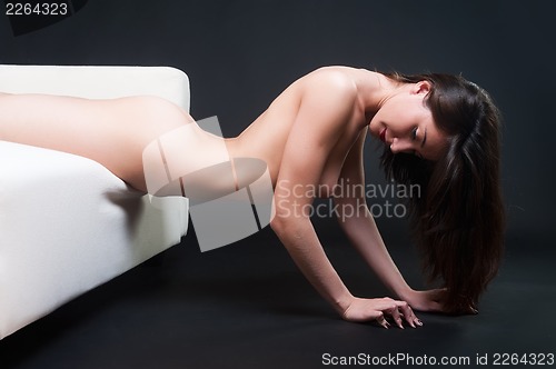 Image of beautiful naked woman on a sofa
