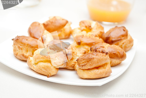 Image of delisious profiteroles on the white plate