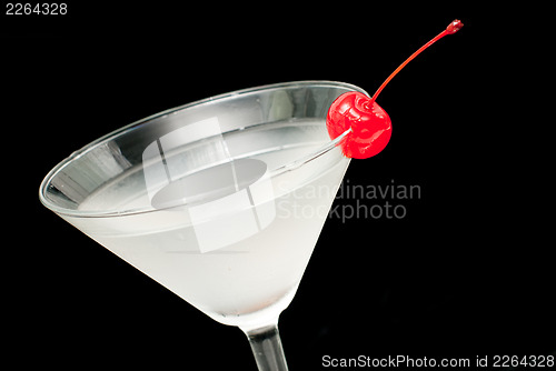 Image of cocktail in martini glass witj red cherry closeup