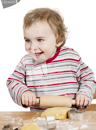 Image of happy young child working with dough in white background