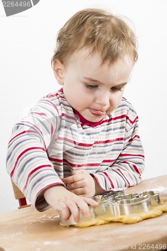 Image of child at desk making cookies