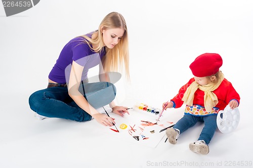 Image of Pretty young mother and daughter drawing