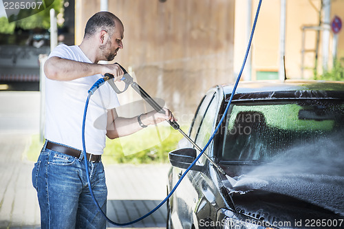 Image of Man washing his car