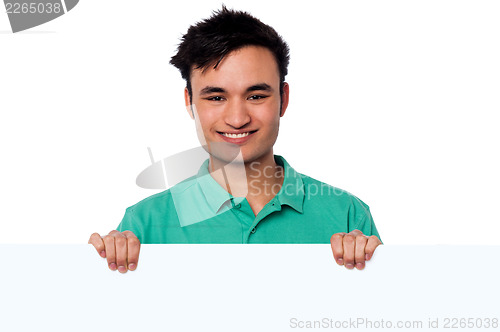 Image of Casual young boy holding blank whiteboard