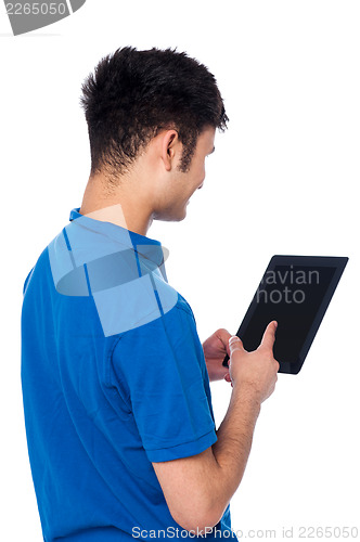 Image of Young guy working on tablet device
