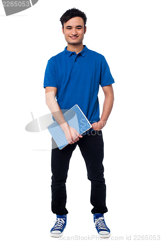 Image of University student posing with notebook