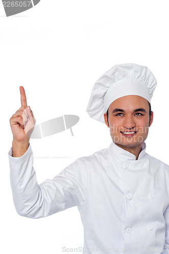 Image of Male chef looking and pointing upwards