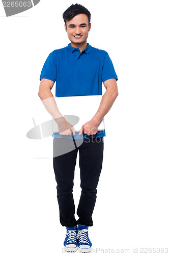 Image of Handsome young man holding laptop