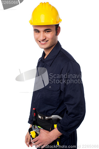 Image of Smiling construction worker in yellow hard hat