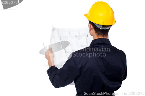 Image of Civil engineer reviewing blueprint