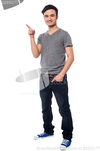 Image of Young man pointing at something interesting