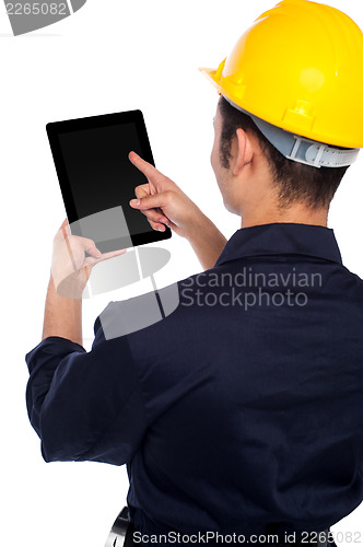 Image of Back pose of worker operating tablet device