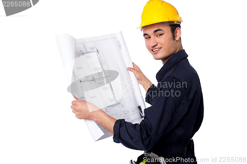 Image of Construction worker reviewing blueprint