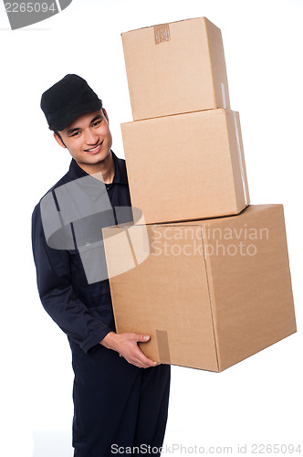 Image of Young courier boy moving boxes