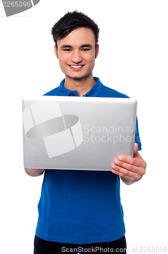 Image of Young guy holding laptop