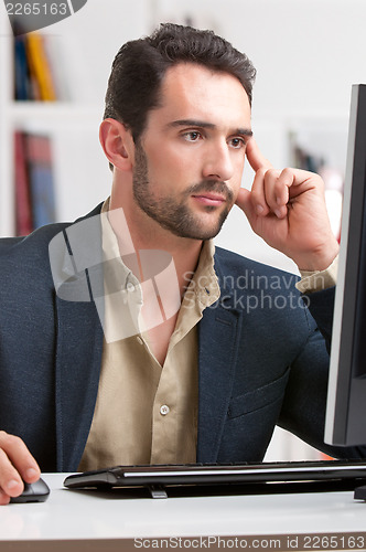 Image of Man Looking At A Computer Monitor