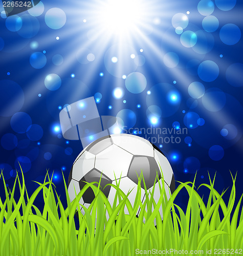 Image of Soccer ball on green grass with shine effect 