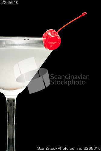 Image of cocktail in martini glass with red cherry closeup