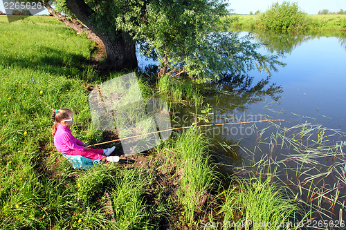 Image of fishing littlle girl on pond