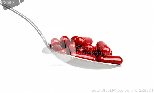 Image of Spoon with red capsules