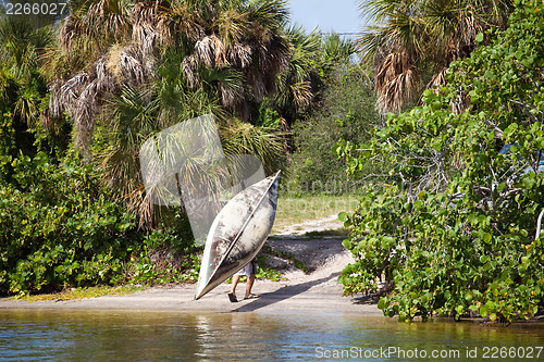 Image of Man Carrying a Canoe