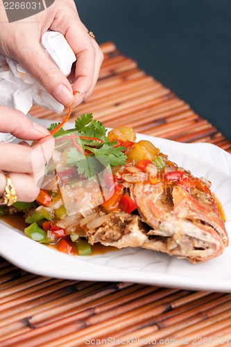 Image of Food Stylist Plating Fish