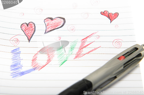 Image of Love Written in Notebook With a Pen.