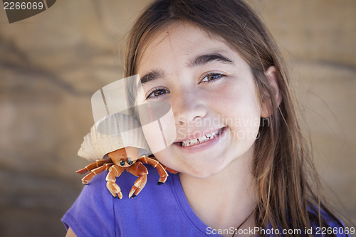 Image of Young Girl Playing with Toy Hermit Crab