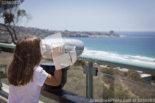 Image of Young Girl Looking Out Over the Pacific Ocean with Telescope