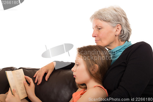 Image of Grandmother read a book with her granddaughter