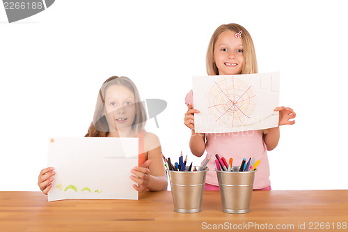 Image of Young girls show their drawings