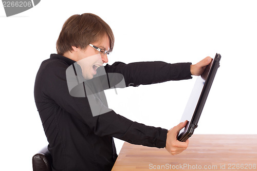 Image of Business man tries to destroy his laptop