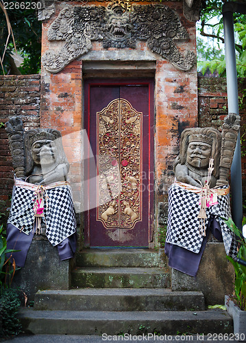 Image of Gates of the old temple with stone guards. Indonesia, Bali.