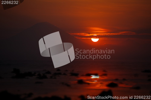 Image of Sunset on the ocean - view of volcano Batur. Indonesia, Bali.