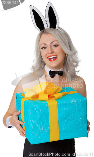 Image of Laughing blonde woman with rabbit ears and a gift