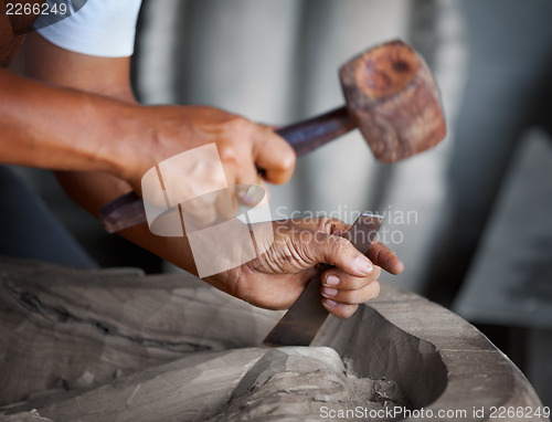 Image of Hands woodcarver with the tools