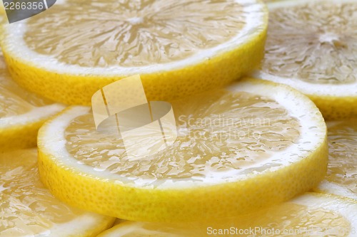 Image of slices of fresh lemon on full screen