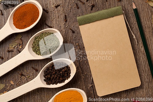 Image of Old notebook, spices in spoons