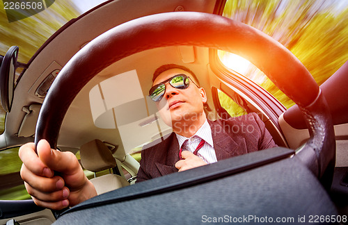 Image of Man driving a car.