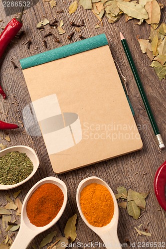 Image of Old notebook, spices in spoons